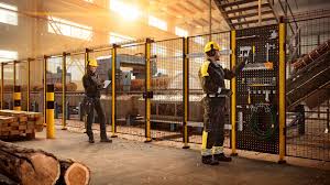 Industrial machine guarding and operator safety systems in a manufacturing facility