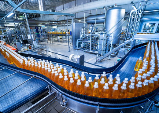 Automated food and beverage production line with conveyor and bottling equipment