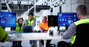 Industrial automation engineers reviewing SCADA system data